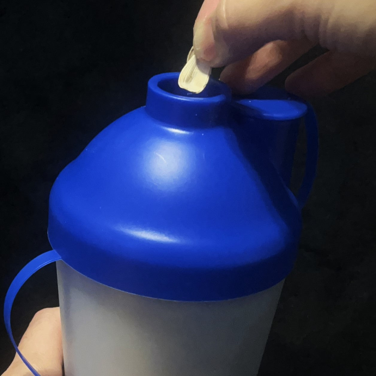 Someone putting shells inside the ProSeed sunflower seed snack cup