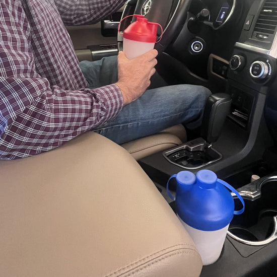 A man in a pickup truck using ProSeed snack cups