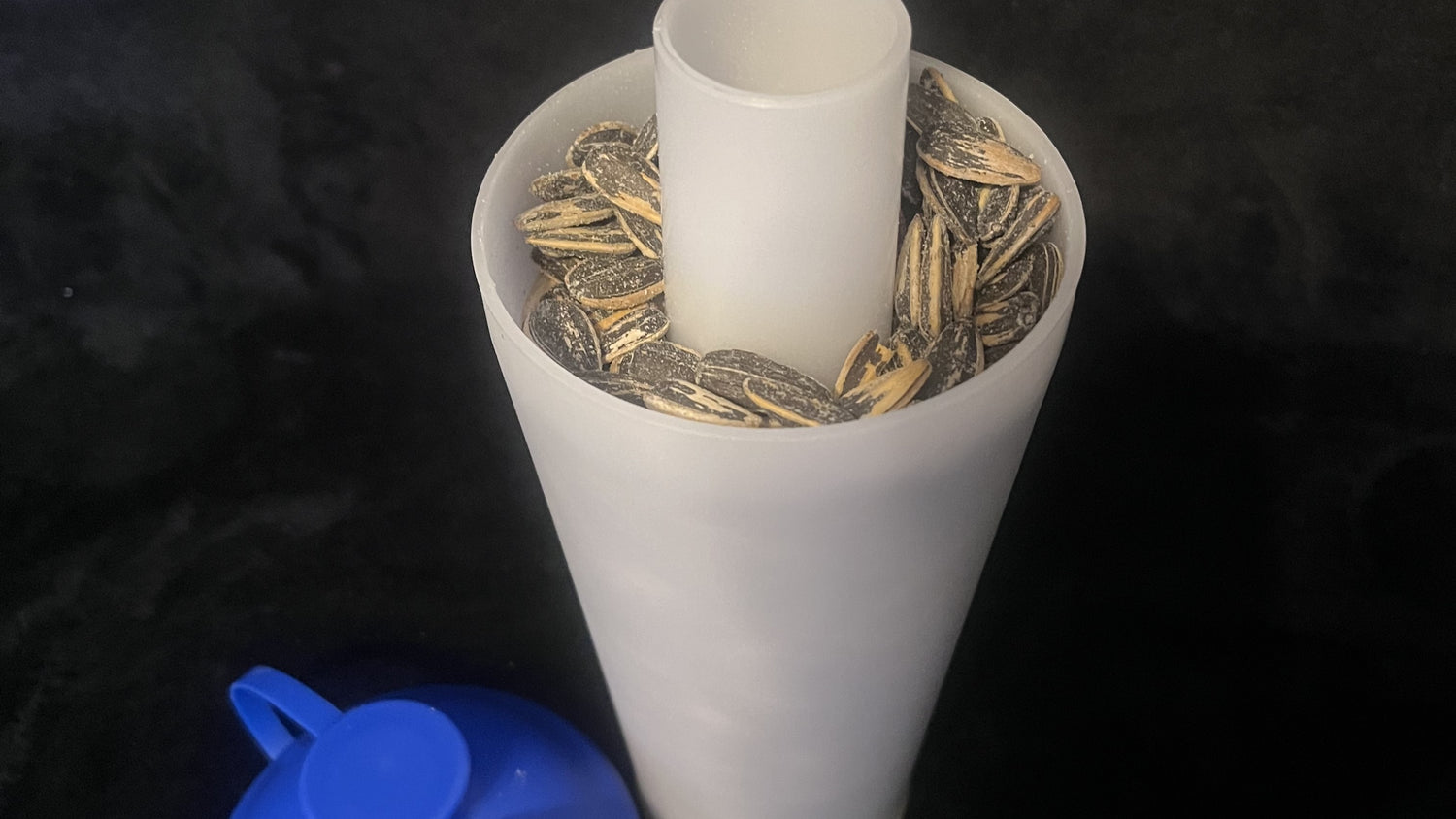 The ProSeed cup with sunflower seeds inside. 
